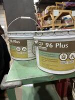Two pails of polyurethane floor covering adhesive
