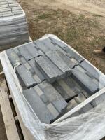 Pallet of black retaining wall concrete blocks