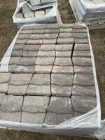 Pallet of reddish gray retaining wall concrete blocks