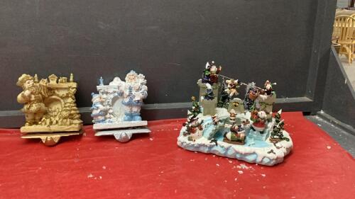 (2) HEAVY RESIN STOCKING HOLDERS W/ CAST BASES AND LIGHTED SNOW VILLAGE