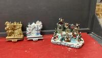 (2) HEAVY RESIN STOCKING HOLDERS W/ CAST BASES AND LIGHTED SNOW VILLAGE