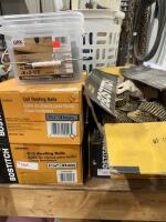 Three full boxes, one partial and a pale of roofing nails