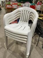 Four plastic stacking chairs