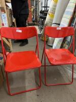Two folding red chairs