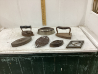 5 ANTIQUE SAD IRONS AND 2 STANDS