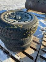 Stack of three tires on aluminum rims