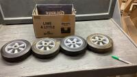 (4) SMALL HARD RUBBER WHEELS ON RIMS