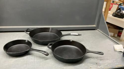 (3) CAST IRON PANS - WOODS , LAGASTINA AND SMALL ONE IS UNMARKED