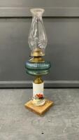 TALL KEROSENE LAMP W/ PORCELAIN BASE & BLUE GLASS RESERVOIR MOUNTED ON WOOD