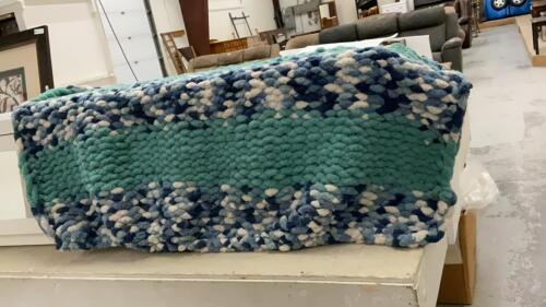 HAND KNOTTED COUCH THROW IN A BLUE RECYCLE TUB