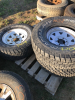 Three truck tires on trailer rims