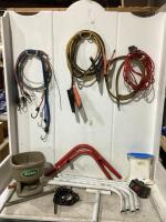 COOLER BOX OF MISC W/ BOOSTER CABLES, STEEL WIRE, SCOTTS SPREADER & RUBBER TUBING