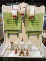 TOTE W/ (3) NURSERY BOTTLE HOLDERS, (7) PLASTIC BOTTLES, (2) PLASTIC FOLDABLE TABLES & (11) ASSORTMENT OF BOTTLE NIPPLES