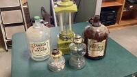 (3)GLASS JUGS, (2)LAMPS W/NO CHIMMNEYS + SPORTSMAN BATTERY LIGHT