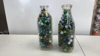 (2) LARGER MILK BOTTLES FILLED W/ MARBLES