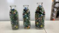 (3) MILK BOTTLES FULL OF MARBLES