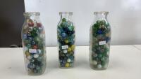 (3) MILK BOTTLES OF MARBLES