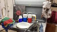BOX W/UMBRELLAS, COOLER JUGS, FISH NET, BACKPACK