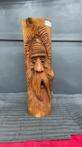 WOOD CARVING OF A FACE OF AN OLD MAN