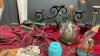 BOX OF DECOR ITEMS - FAKE FLOWERS, WROUGHT IRON CANDLE HOLDER, METAL MATCH HOLDER, MVINTAGE JAR LIFTER, AVON COLOGNE BOTTLES - 3