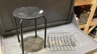 SMALL BLACK STOOL AND A METAL RACK