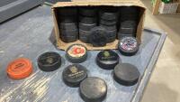 BOX OF ASSORTED USED HOCKEY PUCKS