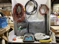TOTE OF 2 TARPS, BATTERY CHARGER, 3 POWER EXTENTION CABLE CORDS, BOOSTER CABLE