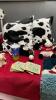 COLLECTION OF COW DECOR - PILLOWS, STUFFIES, ORNAMENTS, MUG AND COASTERS, A RUG, AND A PAPER TOWEL HOLDER - 3
