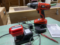 Black & Decker 18 V drill with battery and charger and Makita 9.6 V battery with charger.