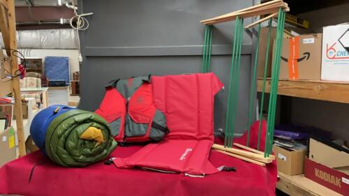 SET OF CAMPING ESSENTIALS - OUTBOUND LIFE JACKET, OUTBOUND CUSHION SEAT, SLEEPING BAG, AND DRYING RACK