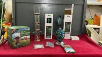 BOX OF ASSORTED YARD AND GARDEN SUPPLIES - (2) OIL TORCHES, (1) HUMMINGBIRD FEEDER AND (2) REGULAR BIRD FEEDERS, HUMMINGBIRD NECTAR PACKAGE