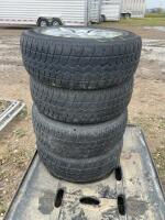 Stack of four tires on Ford rims