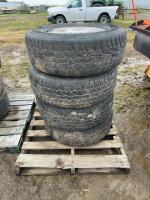 Stack of four tires on GM rims