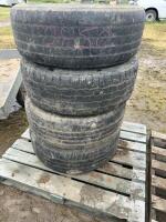 Stack of four tires on rims