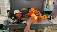 BOX OF HALLOWEEN DECOR - LIGHTED SKULL HEADS, PLASTIC PUMPKIN , GLASS BALL W/ CAT,