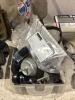 SHOP BOX OF MISCELLANECOUS W/ SAFETY GLASSES, BATTERY TESTER, OIL WRENCH, ANGLE GRINDER GUARDS & METAL WIRE - 4