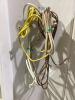 TOTE OF MISCELLANEOUS ELETRONICS W/ CABLES, CASSETTES, REMOTE, BRUSHED & AC ADAPTER - 5