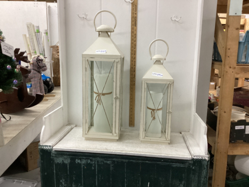 (2) LANTERN TYPE CANDLE HOLDERS. METAL + GLASS. 29” + 21”