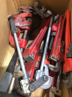 Box of pipe cutters and pipe wrenches