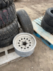 Four matching tires, three aluminum rims ( five bolt) One 5 bolt steel tire and rim - 5