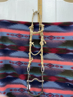 Hand, braided rawhide headstall with Longshank curb bit