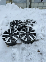 Four Nissan aluminum rims