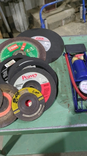 Box of cutting wheels and bicycle pump