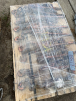 Nine boomers on pallet covered with plastic