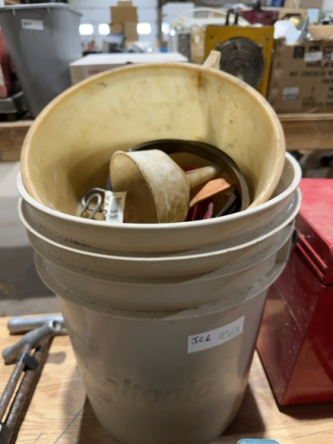 Pail of funnels and oil can