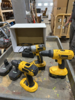 Box of Dewalt drills, batteries, and chargers