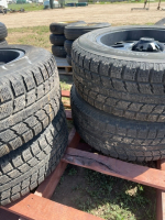 Set of four truck tires on black spoke rims