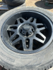 Set of four truck tires on black spoke rims - 4