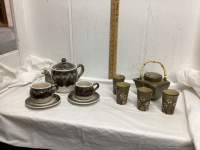 BOX W/ POTTERY TEAPOT W/ (2) CUPS & SUACERS & STOKES TEA SET