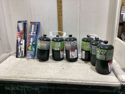 BOX W/ (6) PROPANE BOTTLES & (2) LIGHTERS